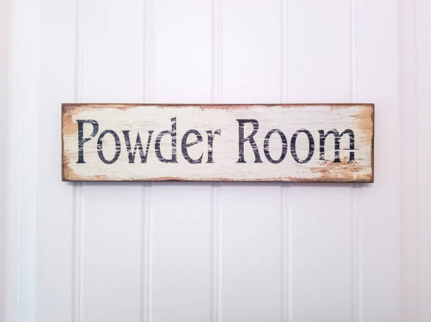 istock Rustic rectangular wooden Powder Room sign against white panelled door 1298057854