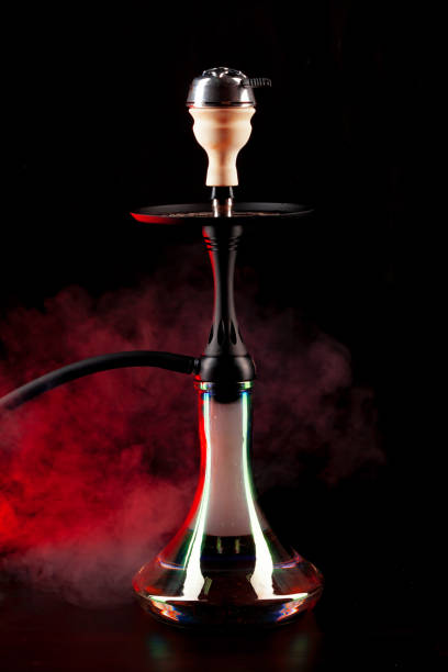 istock Smoking hookah on black background with color fog 1298059639