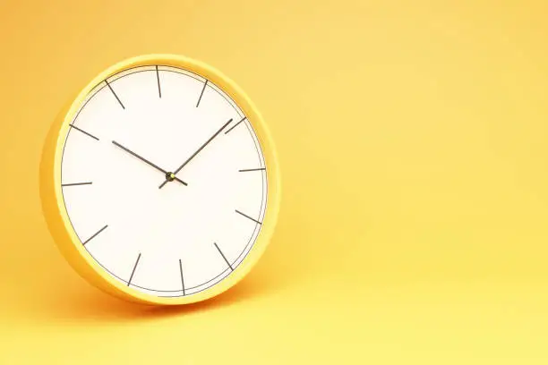 Photo of Yellow round table clock on a yellow background 3d rendering