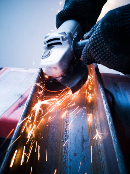 Sawing metal sparks Sawing metal with circular saw sparks close up worker with grinding machine power tool in factory stock pictures, royalty-free photos & images