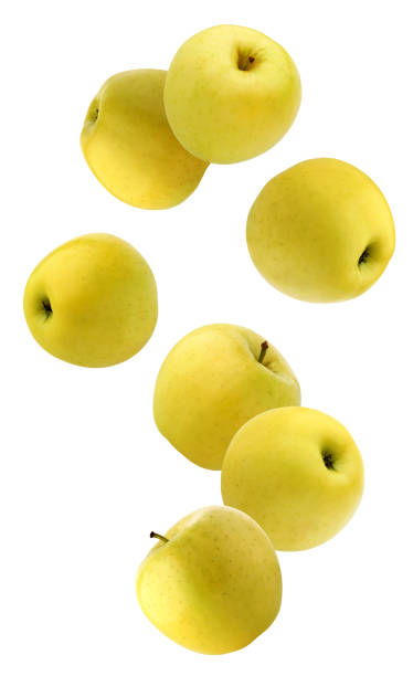 istock falling  yellow apples isolated on a white background with a clipping path. 1298068293