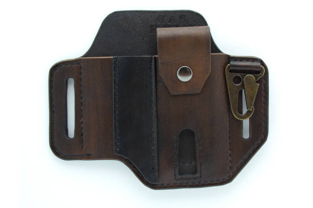 istock Dark brown custom handmade pancake style leather belt sheath isolated on white background. Leather belt sheath for knife and multi tool. 1298068474