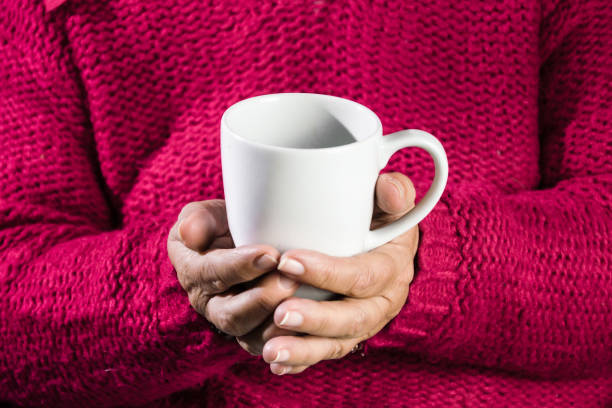 istock Woman with cup of coffee in hands 1298070257