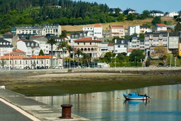 istock Fishing boat and coastal village 1298071709