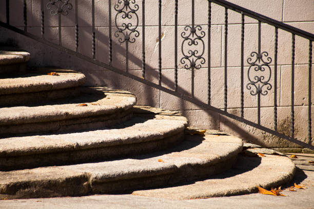 istock Ancient stone staircase and cast iron railing in the sunlight. 1298071742