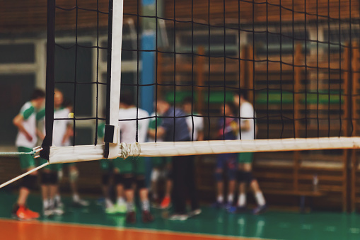 Selective focus: Coach analyze game of volleyball team during timeout in sports gym. Background for team volleyball game. Concept of getting sport, healthy lifestyle and team success. Copy space