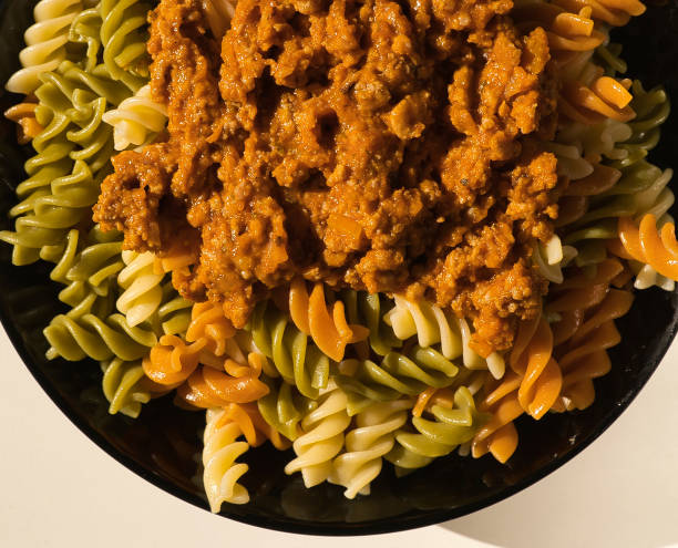 istock a black plate of fresh italian boiled pasta fusilli with meat served on a withe table 1298077375