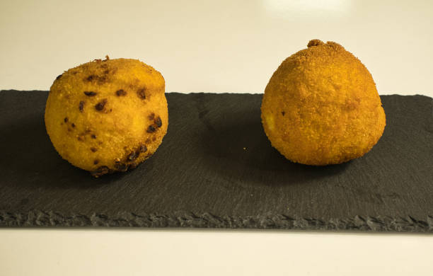 istock Italian appetizer arancini, rice balls stuffed with meat cooked in deep fat 1298077429