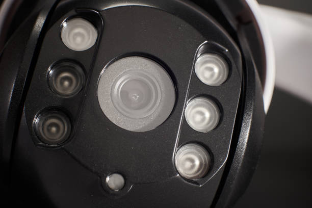 istock surveillance camera isolated on black background, studio shot 1298081112