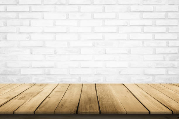 istock Empty wooden table top on white brick wall background, Design wood terrace white. Perspective for show space for your copy and branding. Can be used as product display montage. Vintage style concept. 1298084014