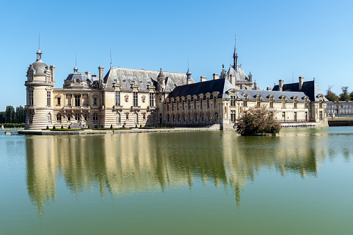 Chantilly, France - September 21 2020: Chateau de Chantilly with reflection in the lake - France
