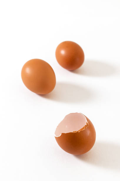 istock Fresh chicken whole eggs and a broken egg isolated on white background. 1298085470