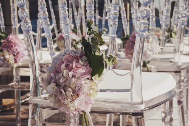 Wedding chairs with roses in wedding ceremony room