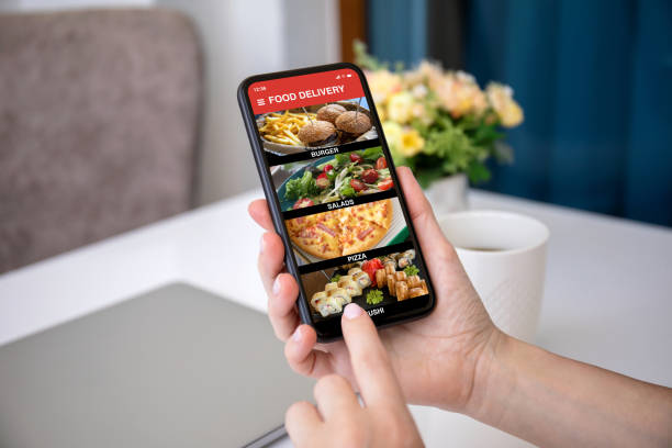 istock female hands hold phone with food delivery application on screen 1298086737