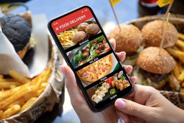 istock female hands hold phone with food delivery application on screen 1298086950