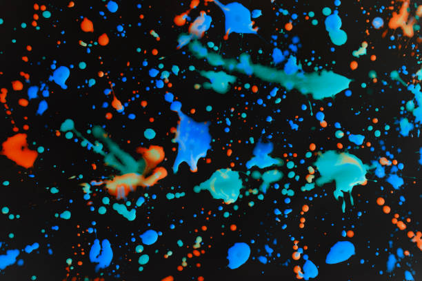 istock Speckled paint of different colors on a black background 1298086999