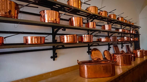 istock Kitchen of the old castle. Copper pans, baking molds and other kitchen utensils 1298091954