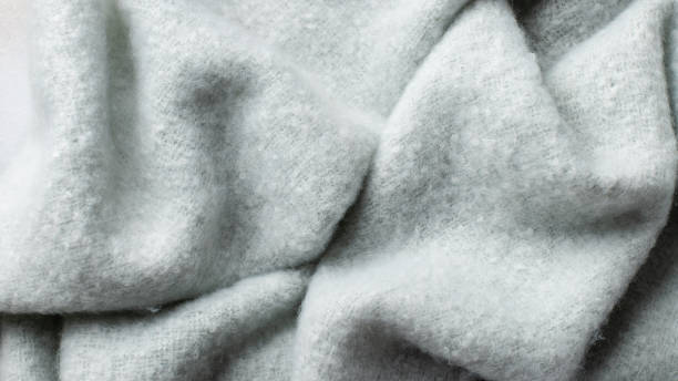 istock delicate blue fluffy background of plush fabric with folds 1298092930