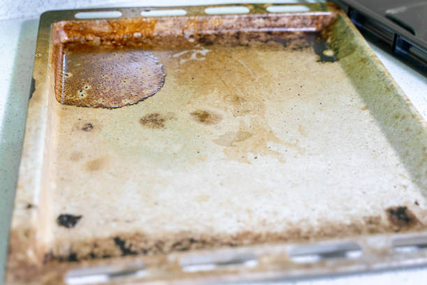 istock dirty baking tray covered with grease and streaks 1298094105