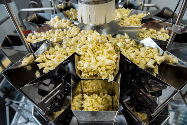 istock Vertical multi-head weigher packaging machine snacks and chips in a factory 1298094353
