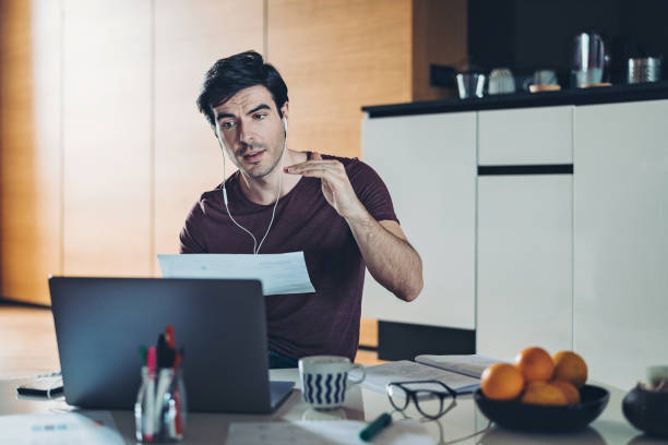 man working from home in a video conference - credit crunch audio imagens e fotografias de stock