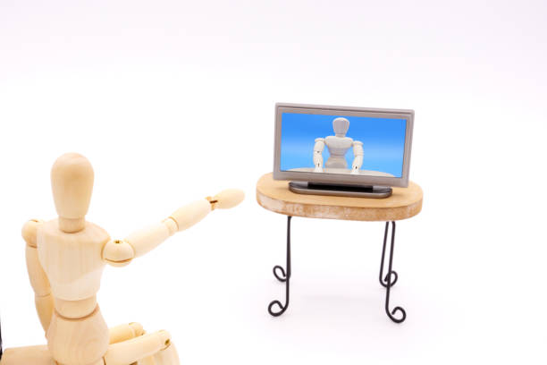 istock A drawing doll pointing out to the TV screen 1298097009