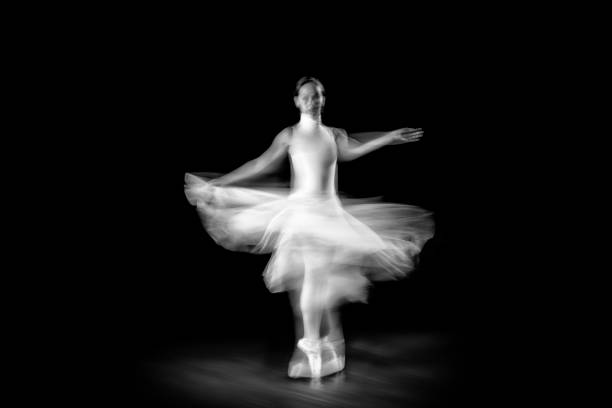 istock Dancing ballerina on a black background 1298097593