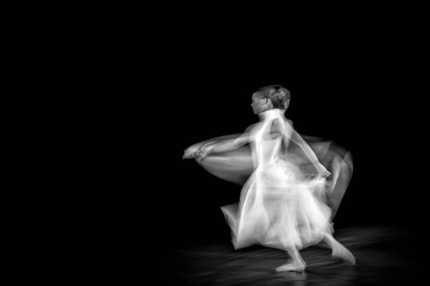 istock Dancing ballerina on a black background 1298097619