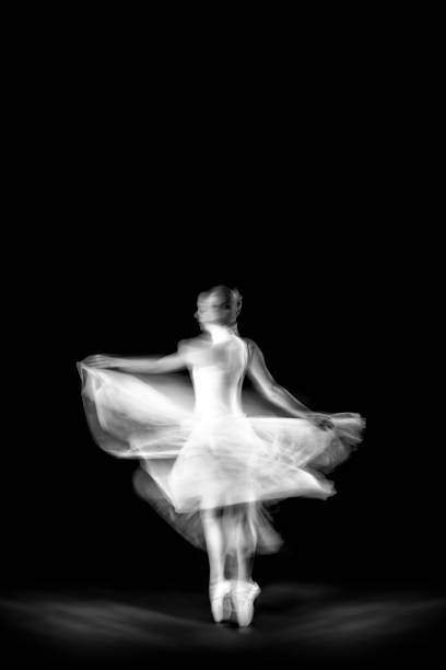 istock Dancing ballerina on a black background 1298097657