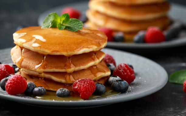 American pancakes with fresh blueberry, raspberry and honey. Healthy morning breakfast American pancakes with fresh blueberry, raspberry and honey. Healthy morning breakfast. crêpe pancake stock pictures, royalty-free photos & images