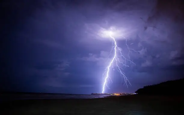 Lightening storm moving in over beach.