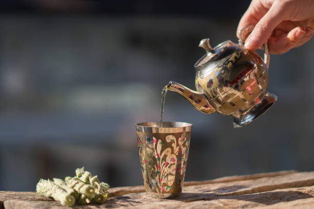 istock woman pouring tea on the balcony. 1298100345