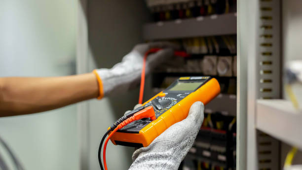 istock Electrician engineer uses a multimeter to test the electrical installation and power line current in an electrical system control cabinet. 1298103276