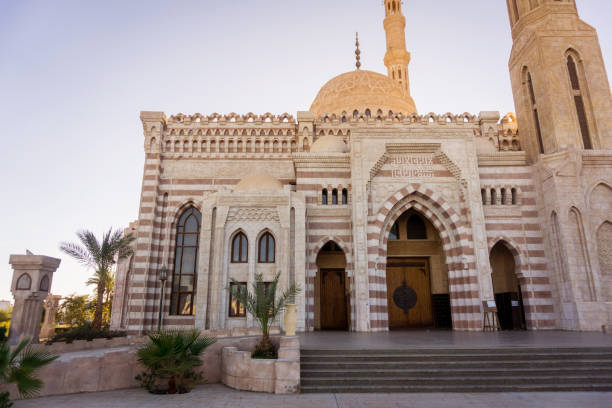 istock Beautiful large Islamic mosque at the sky background 1298103662