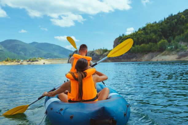 istock Lovely young couple on a kayak rowing 1298105055