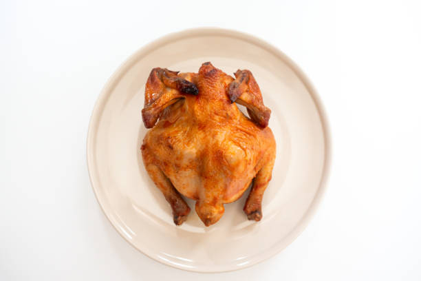 Man Taking Barbecue Chicken Drumstick Off Plate