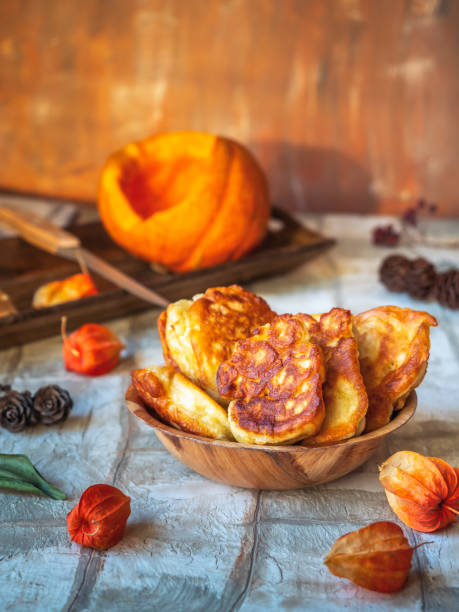 istock Pumpkin pancakes in a deep plate and cut pumpkin on the drill table 1298105111