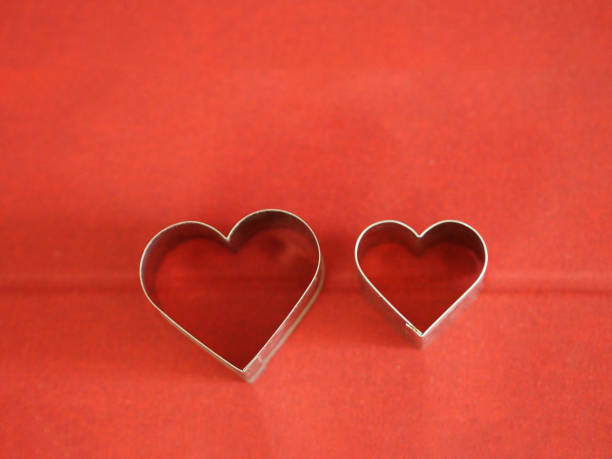 istock bread molds stainless Heart shaped on red background, love Valentine Day for copy text card, background 1298105236