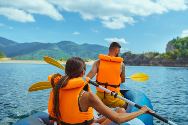 istock Man and woman kayaking on lake 1298105303