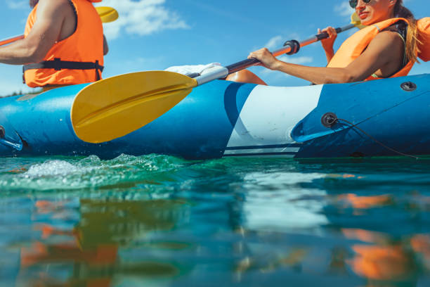 istock Paddling young couple on the river 1298105542