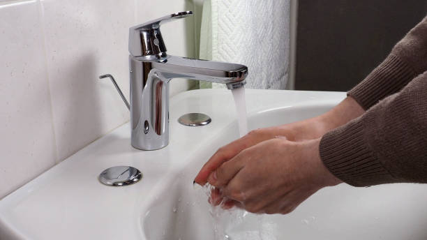 istock Unrecognisable person washing hands 1298107870