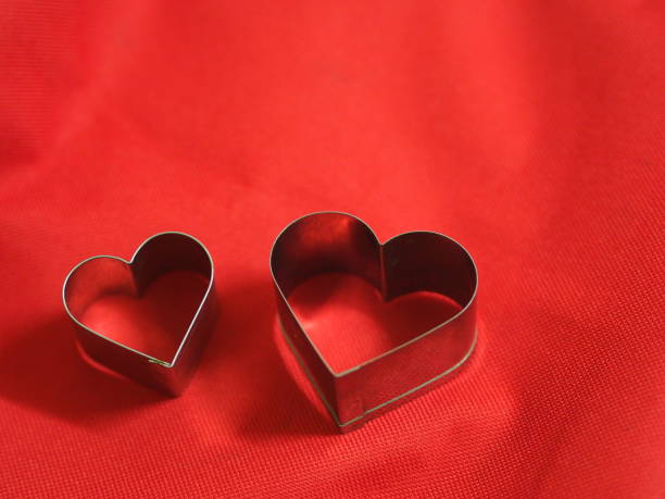 istock bread molds stainless Heart shaped on fabric red background, love Valentine Day for copy text card, background 1298109311