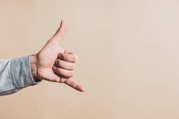 istock Male hand showing call me gesture 1298109343