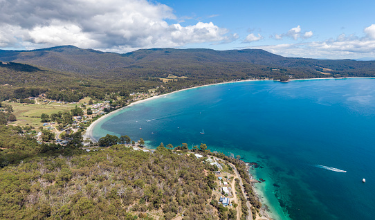 Stunning high angle aerial drone view of Adventure Bay on the eastern side of Bruny Island, Tasmania. The area is a popular tourist destination. Captain James Cook landed in Adventure Bay in 1777.