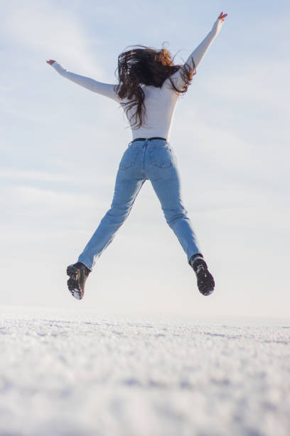 istock girl jumped happily on a sunny winter day 1298111983