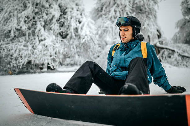 istock Snowboarder sitting and enjoying the mountain view 1298113686