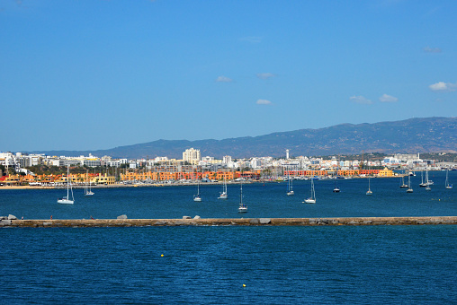 Portimão, Algarve / Faro District, Portugal: Portimão skyline and the estuary of the Arade river with Serra de Monchique mountains in the background. The river marks the border between the municipalities of Lagoa and Portimão, on the left and right banks. respectively.