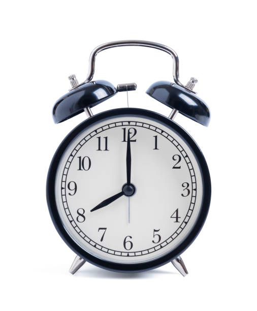 istock Closeup retro black alarm clock isolated on white background 1298113721