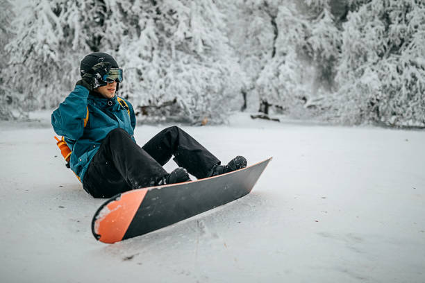 istock Snowboarder sitting and enjoying the mountain view 1298113722