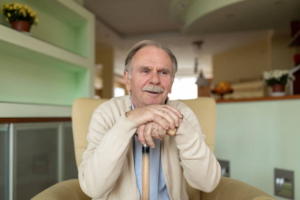istock Lonely Senior Man is Sitting on Sofa at Home and Looking Confident. 1298114873